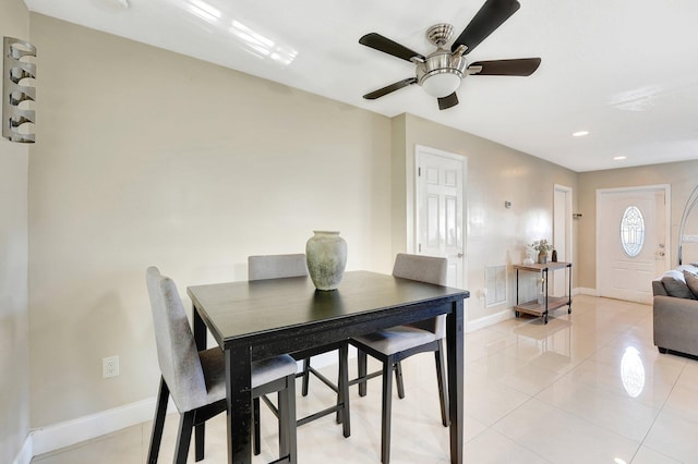 tiled dining room with ceiling fan