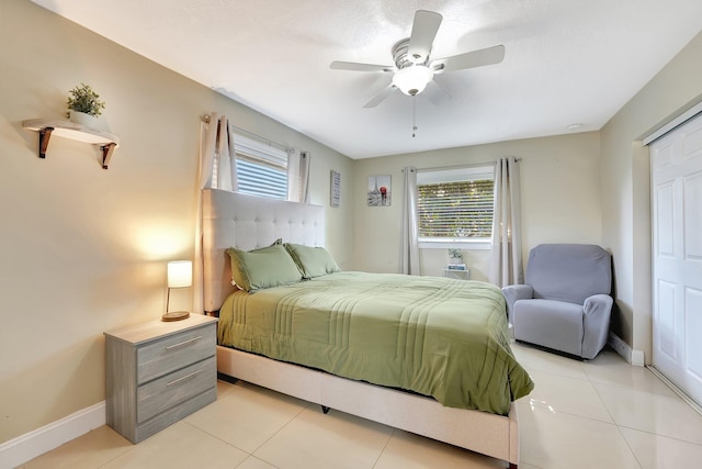 tiled bedroom featuring ceiling fan