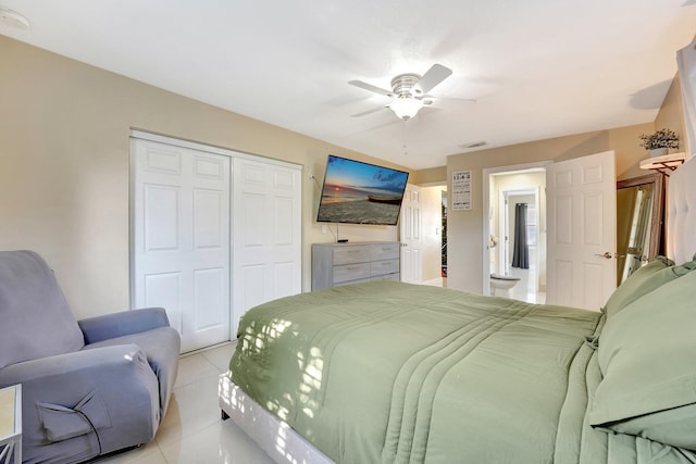 bedroom featuring light tile patterned floors, a closet, and ceiling fan