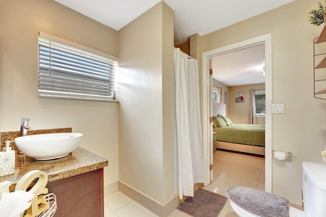 bathroom featuring tile patterned floors, vanity, and toilet