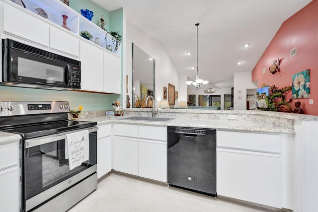 kitchen featuring a chandelier, appliances with stainless steel finishes, pendant lighting, vaulted ceiling with skylight, and white cabinets