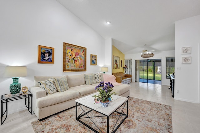 tiled living room featuring ceiling fan and lofted ceiling