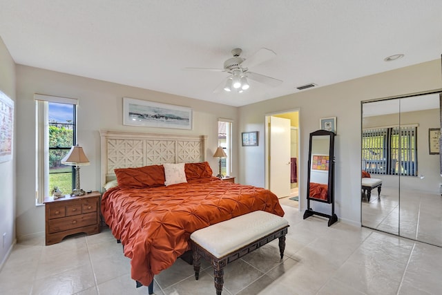 tiled bedroom featuring a closet and ceiling fan