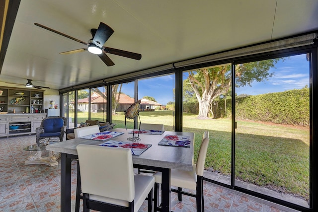 sunroom featuring ceiling fan