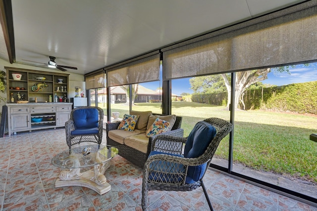 sunroom / solarium featuring a wealth of natural light and ceiling fan