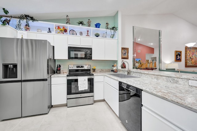 kitchen with vaulted ceiling, sink, white cabinets, light tile patterned floors, and black appliances