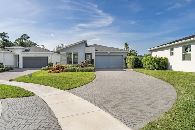 single story home featuring a garage and a front lawn