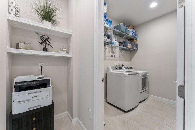 laundry area with light tile patterned flooring and separate washer and dryer