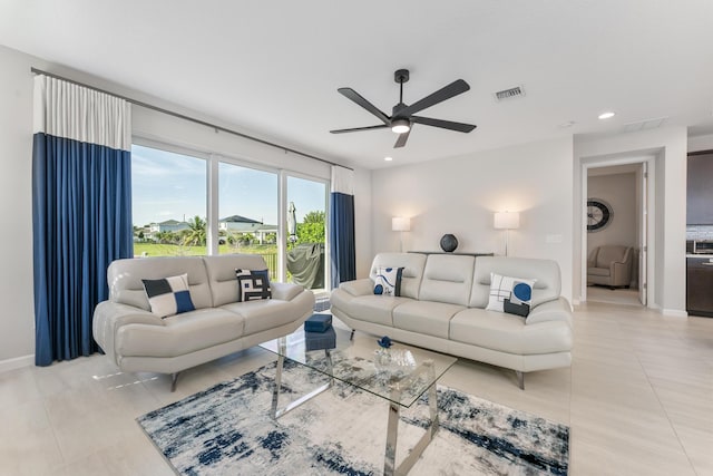 tiled living room featuring ceiling fan