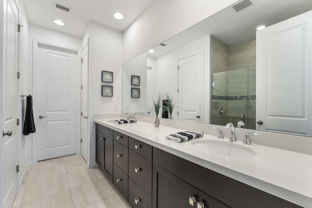 bathroom featuring walk in shower, vanity, and tile patterned flooring