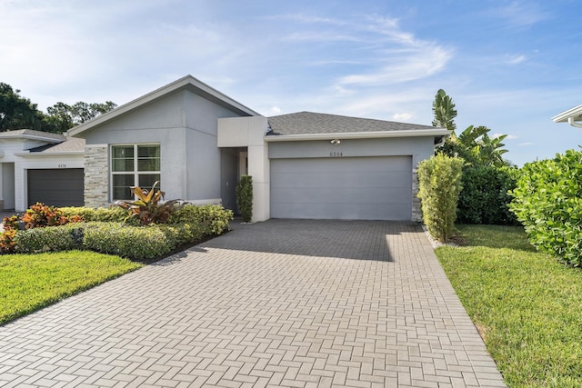 view of front of home featuring a garage and a front lawn