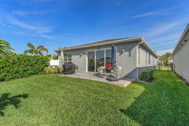 rear view of property with a patio area and a lawn