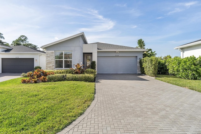 view of front of home featuring a garage and a front lawn