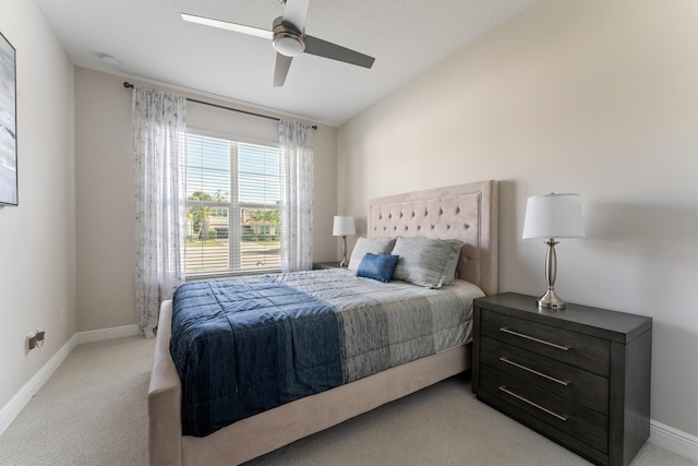 carpeted bedroom featuring ceiling fan and vaulted ceiling