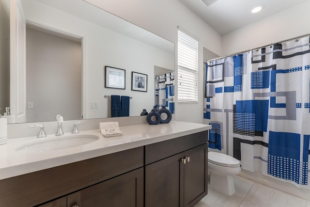 full bathroom featuring vanity, shower / tub combo with curtain, tile patterned floors, and toilet