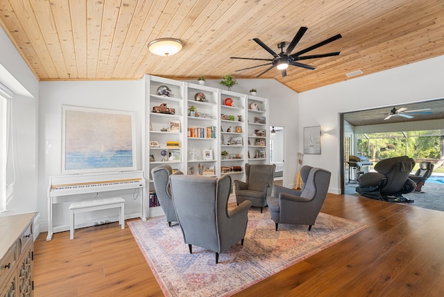 sitting room featuring ceiling fan, vaulted ceiling, light hardwood / wood-style flooring, and wooden ceiling