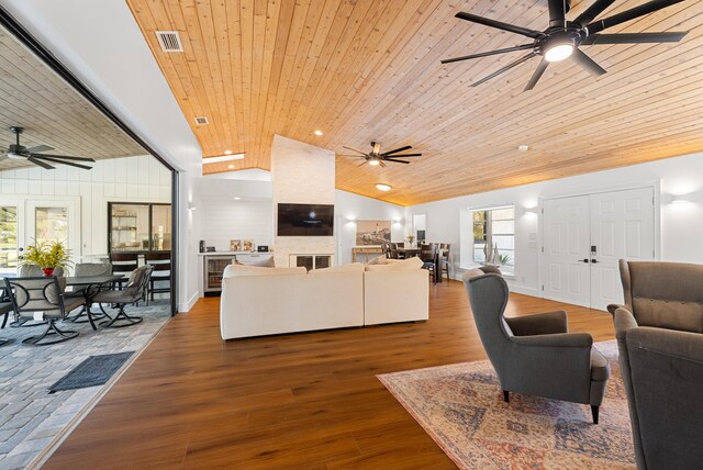 living room with wood ceiling, wood-type flooring, and high vaulted ceiling