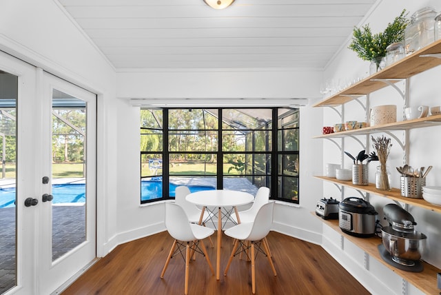 sunroom / solarium featuring lofted ceiling, wood ceiling, and french doors