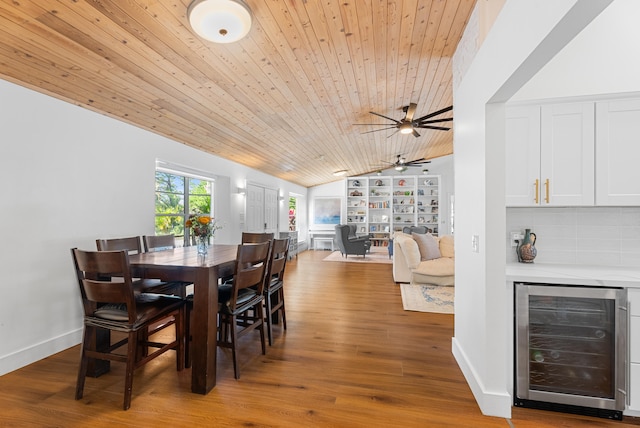 dining area with vaulted ceiling, hardwood / wood-style floors, beverage cooler, ceiling fan, and wooden ceiling