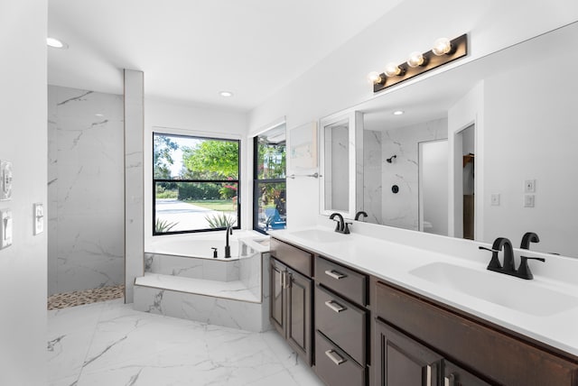 bathroom with vanity and independent shower and bath