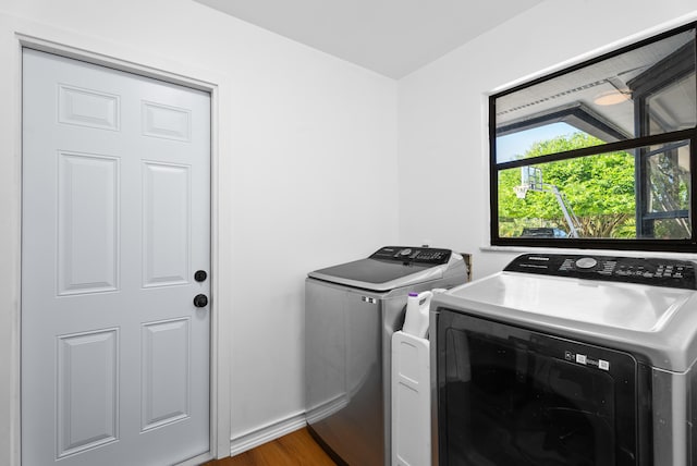 washroom featuring separate washer and dryer and dark hardwood / wood-style floors