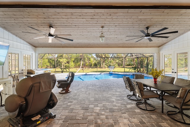 view of pool with a lanai, a patio, and ceiling fan