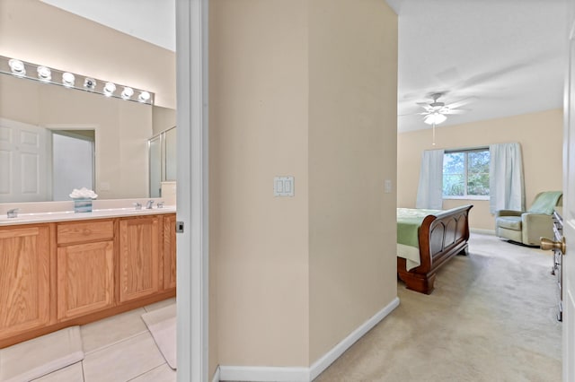 bathroom featuring ceiling fan and vanity