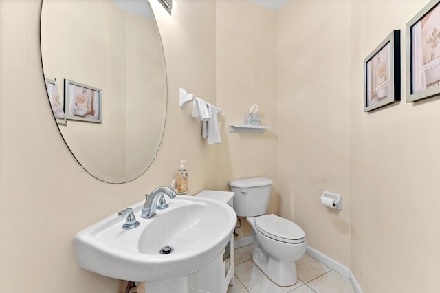 bathroom featuring toilet, sink, and tile patterned floors