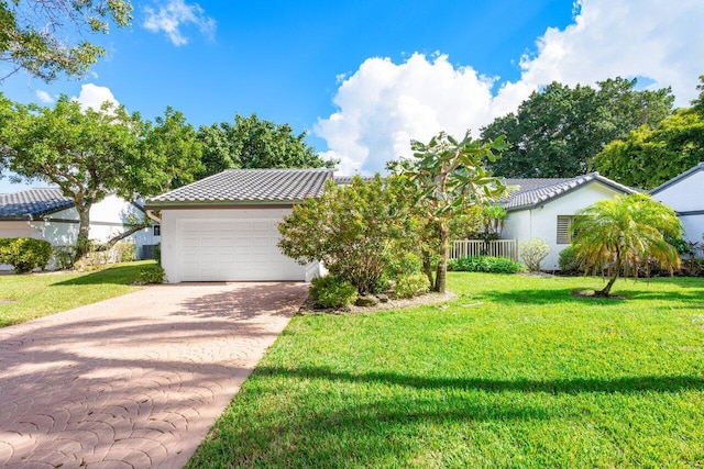 view of front of property featuring a garage and a front yard