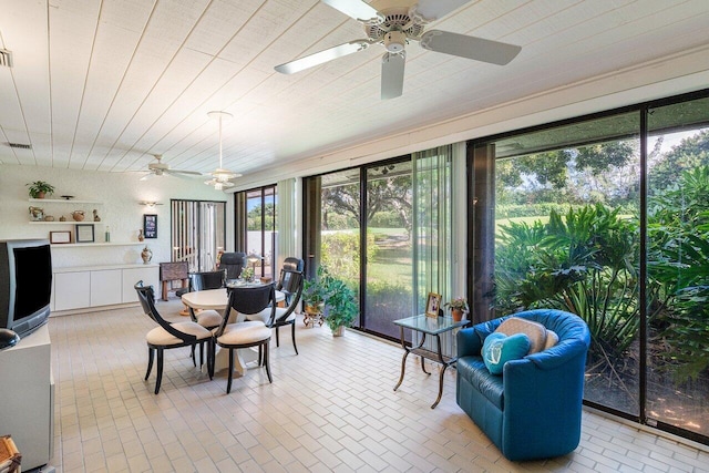 sunroom with ceiling fan and a healthy amount of sunlight