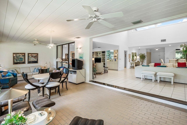 interior space featuring ceiling fan and wooden ceiling