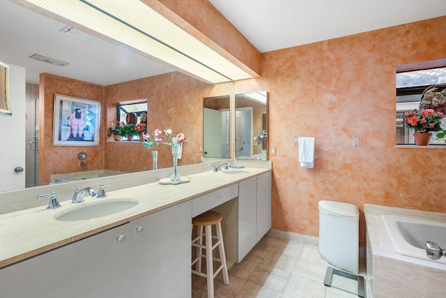 bathroom featuring vanity and tiled tub