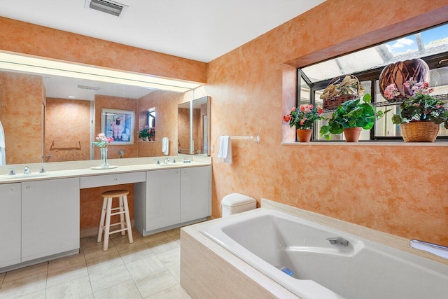 bathroom with tiled tub and vanity