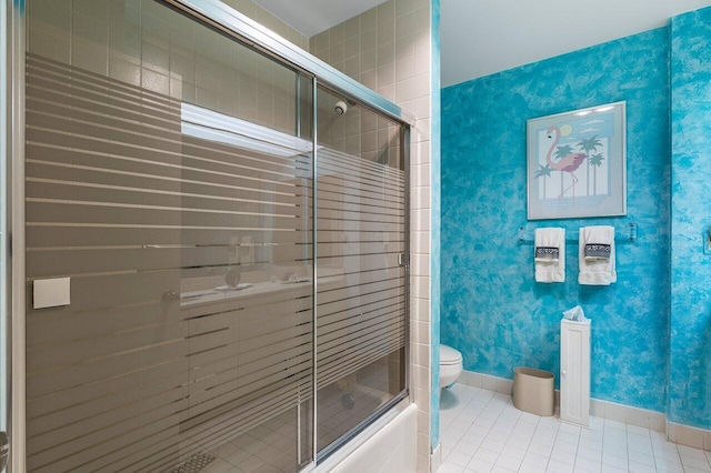 bathroom featuring tile patterned floors, enclosed tub / shower combo, and toilet