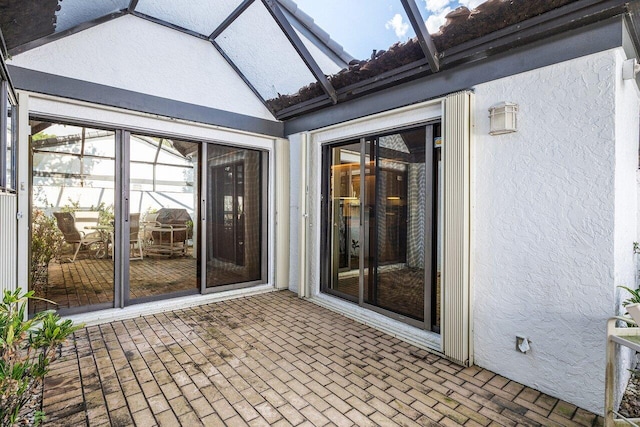 unfurnished sunroom featuring lofted ceiling