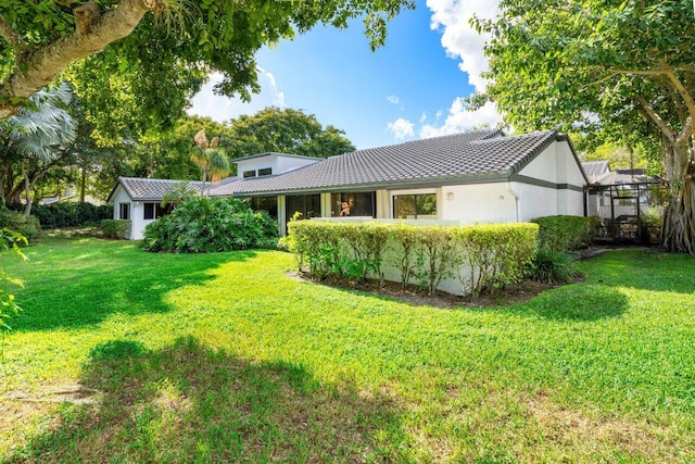 back of property featuring a lawn