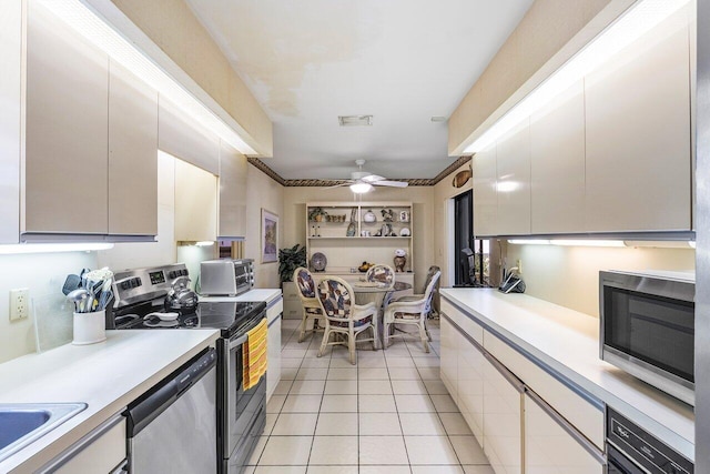 kitchen featuring appliances with stainless steel finishes, ceiling fan, and light tile patterned flooring