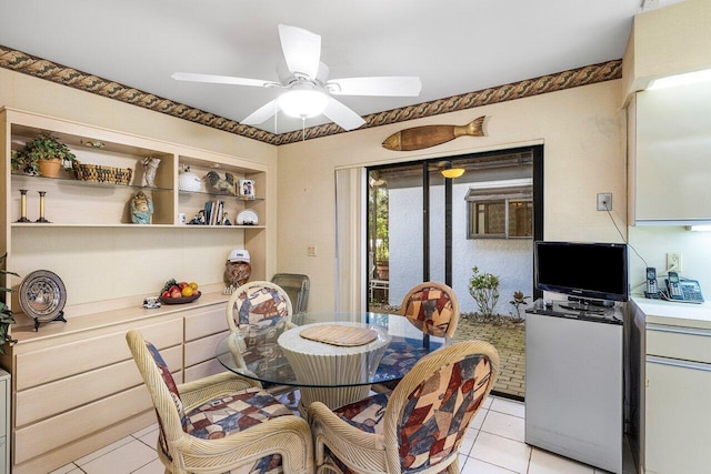 dining area with ceiling fan and light tile patterned flooring