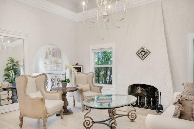 living room featuring ornamental molding, a high end fireplace, light wood finished floors, and an inviting chandelier