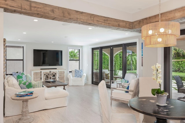 living area with recessed lighting, french doors, baseboards, and light wood finished floors