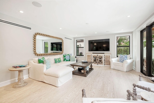 living area with recessed lighting, wood finished floors, and baseboards