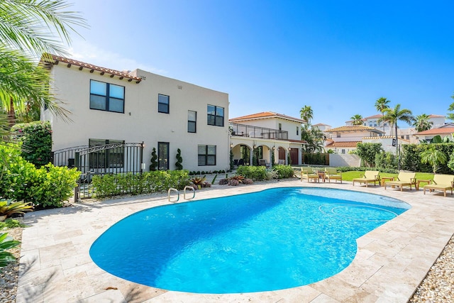 view of swimming pool featuring a patio, fence, and a fenced in pool