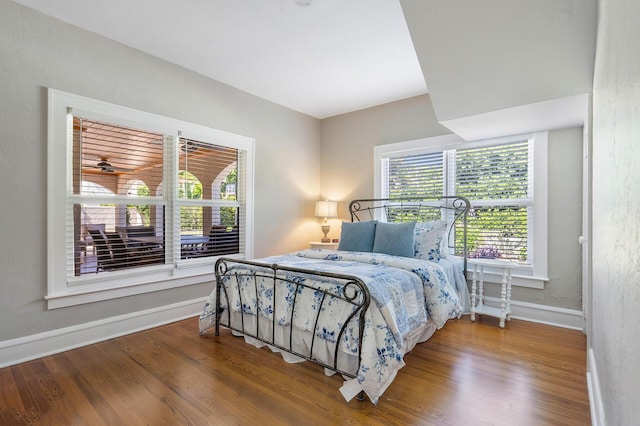 bedroom featuring baseboards and wood finished floors