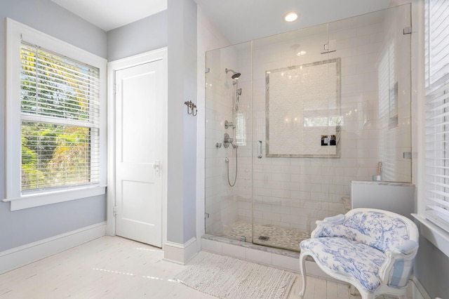 full bath featuring a stall shower, recessed lighting, and baseboards