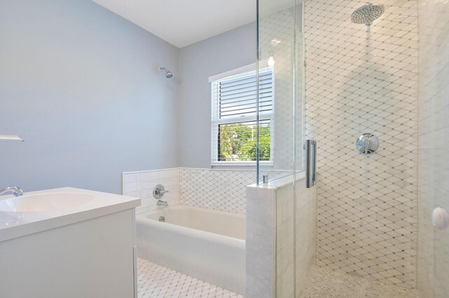 full bath featuring tile patterned floors, a garden tub, vanity, and a shower stall