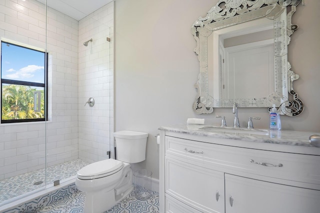 full bath featuring a stall shower, vanity, toilet, and tile patterned floors