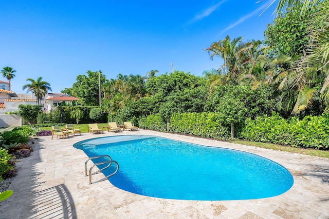 view of swimming pool with a patio area, fence, and a fenced in pool