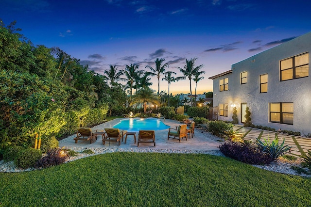 pool with a patio and a yard