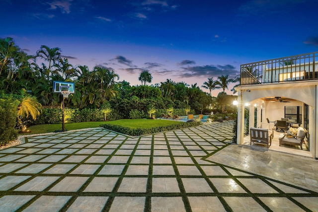 view of patio / terrace with a balcony, an outdoor living space, and a ceiling fan