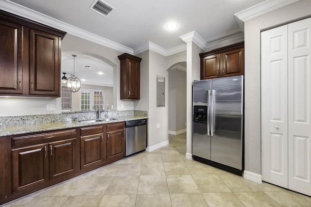 kitchen featuring sink, crown molding, light stone countertops, stainless steel appliances, and a chandelier